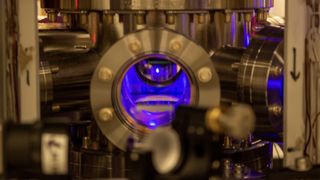 To create the optical atomic clocks, researchers cooled strontium atoms to near absolute zero inside a vacuum chamber. The chilling caused the atoms to appear as a glowing blue ball floating in the chamber.