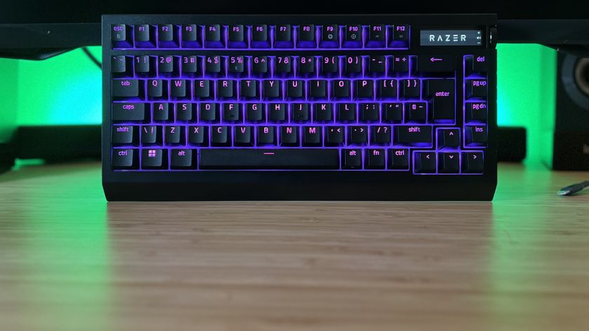 Razer BlackWidow V4 Pro 75% gaming keyboard with purple RGB lighting on a desk setup