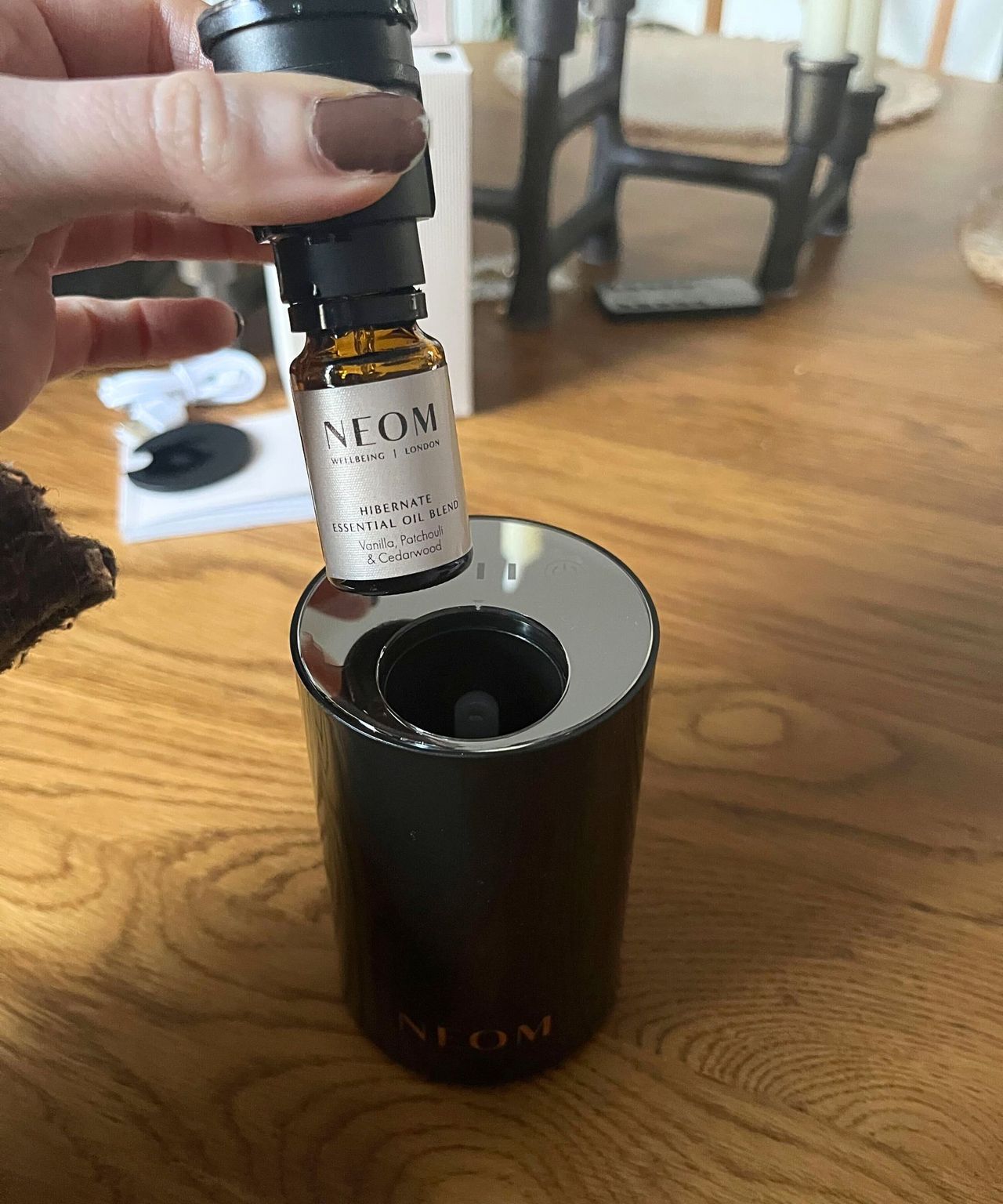 The NEOM essential oil bottle in the diffuser cap