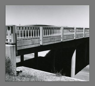 A black and white photograph of a bridge