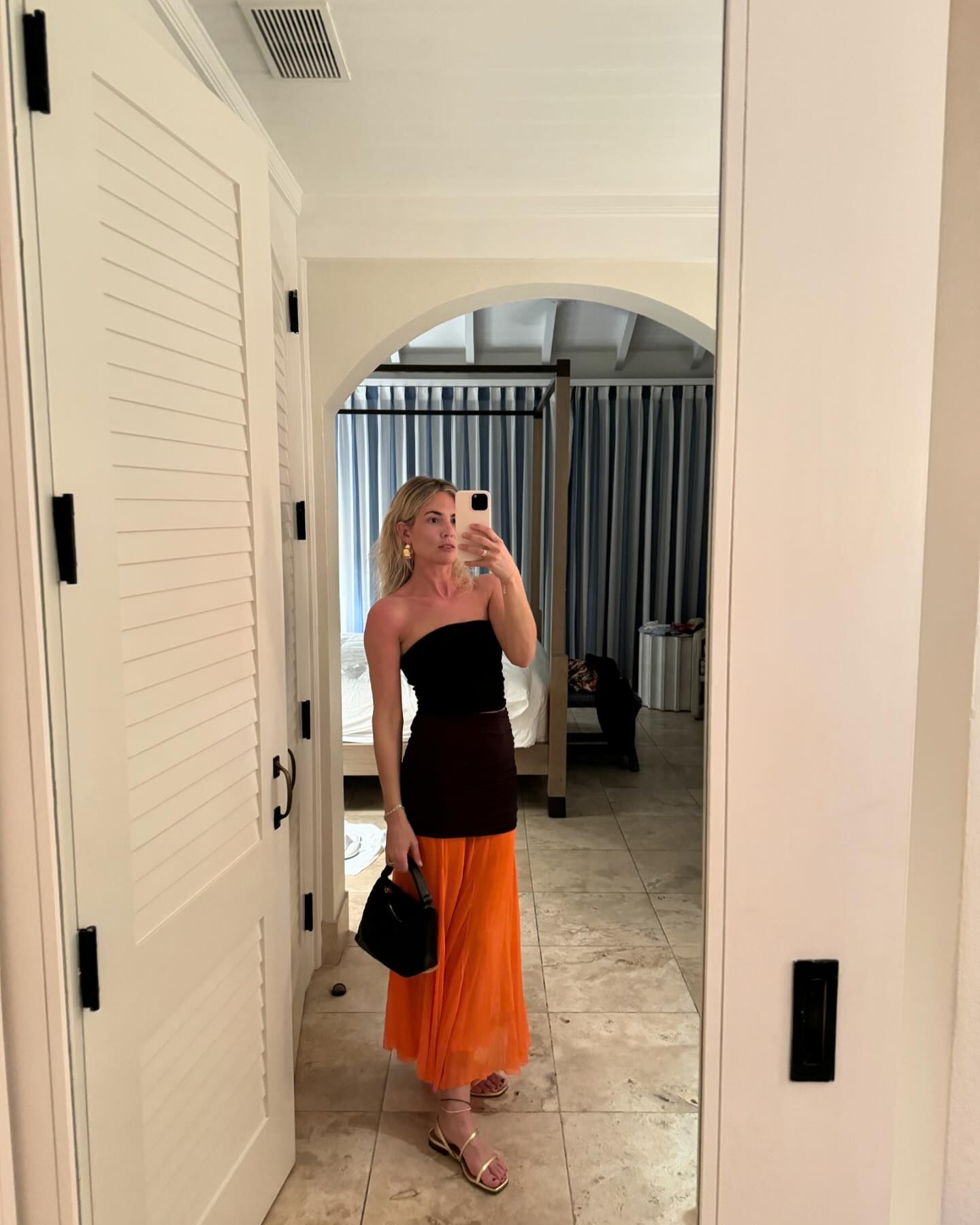 Lucy Williams wearing a brown-and-orange Tory Burch skirt with a tube top.