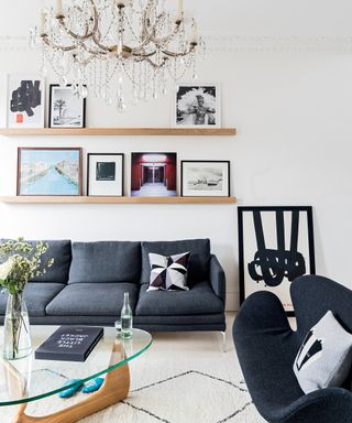 Small living room idea with dark sofas and open shelving