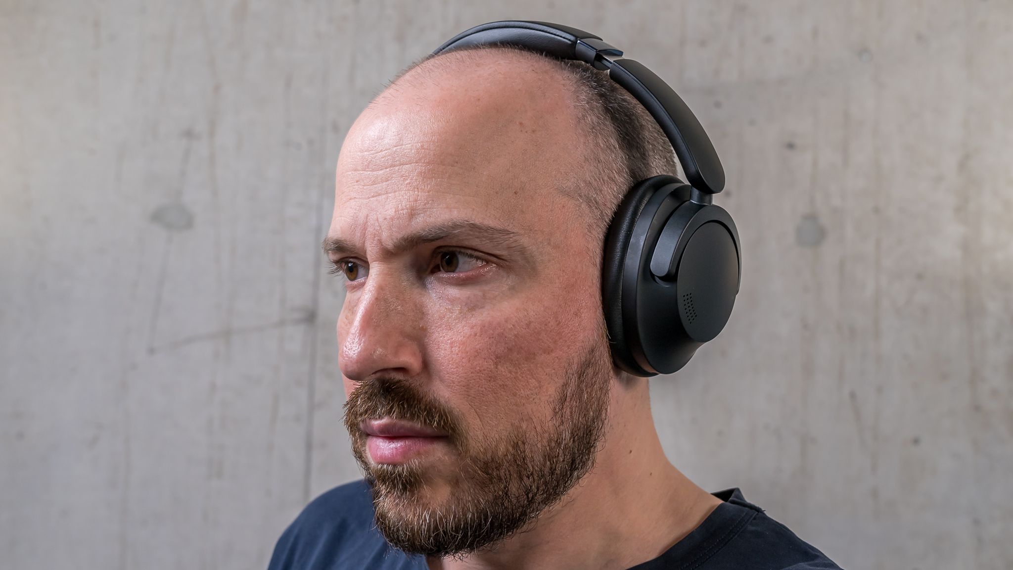 Wearing the 1More SonoFlow Pro HQ51 over-ear headphones.