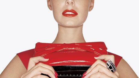 model with red calculator purse