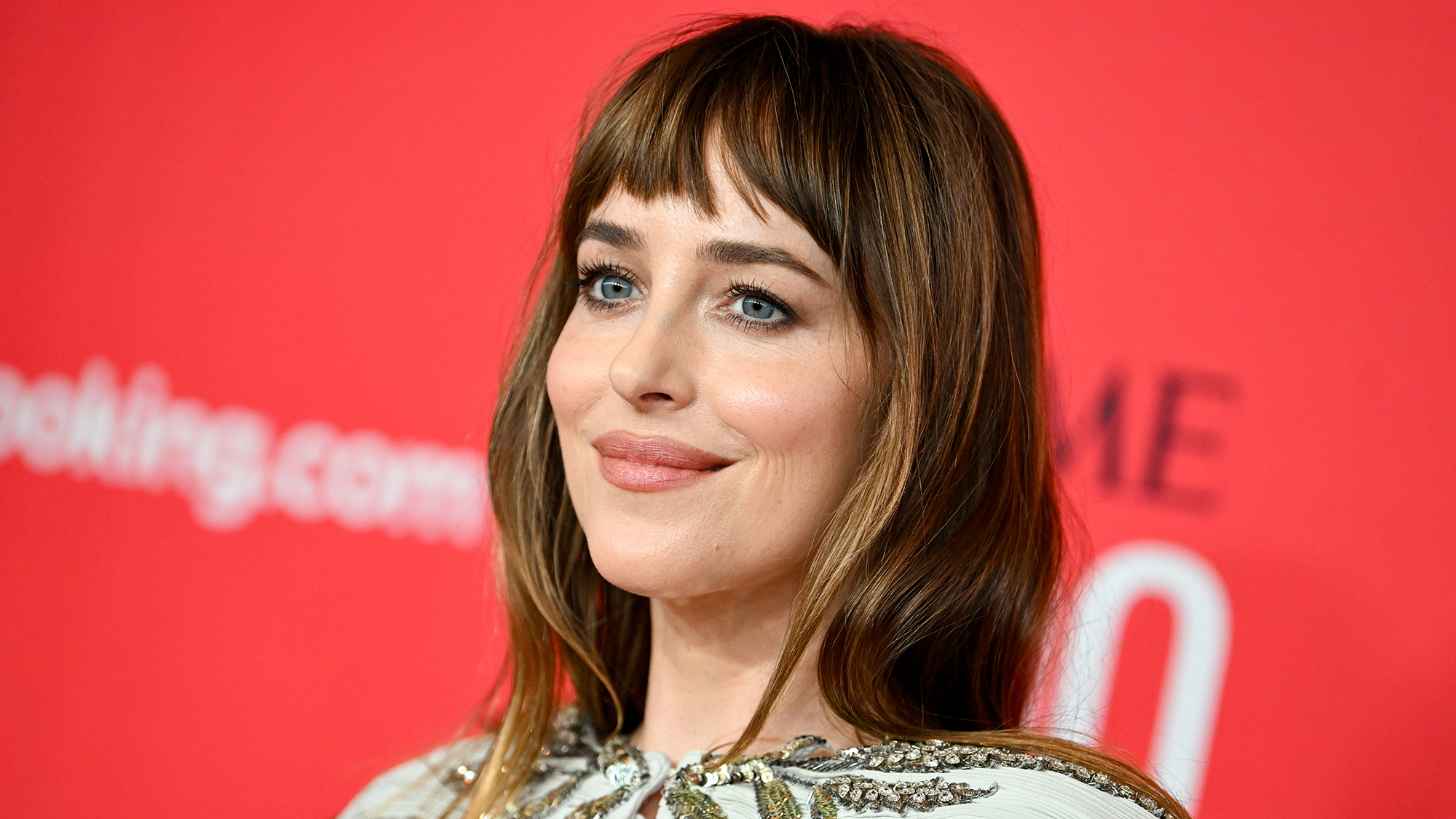 Headshot of Dakota Johnson at the 2026 TIME100 Gala in front of a red backdrop