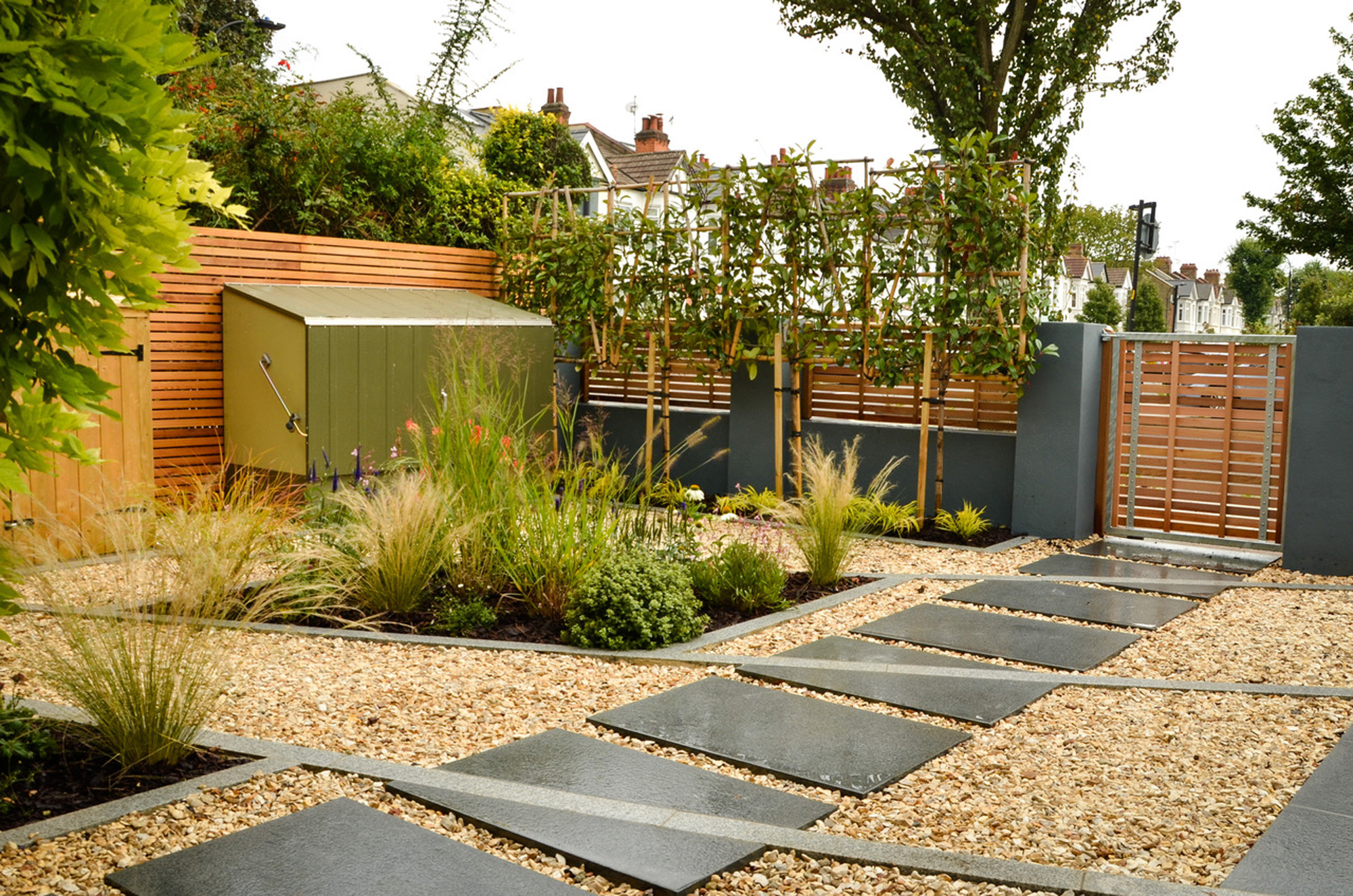 contemporary dark grey front garden wall with slatted cedar fencing on top