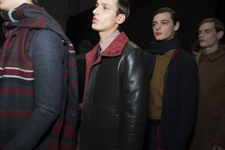 Four male models stood in a line behind each other