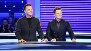 Ant and Dec wearing suits and standing in the studio smiling in Ant and Dec's Limitless Win