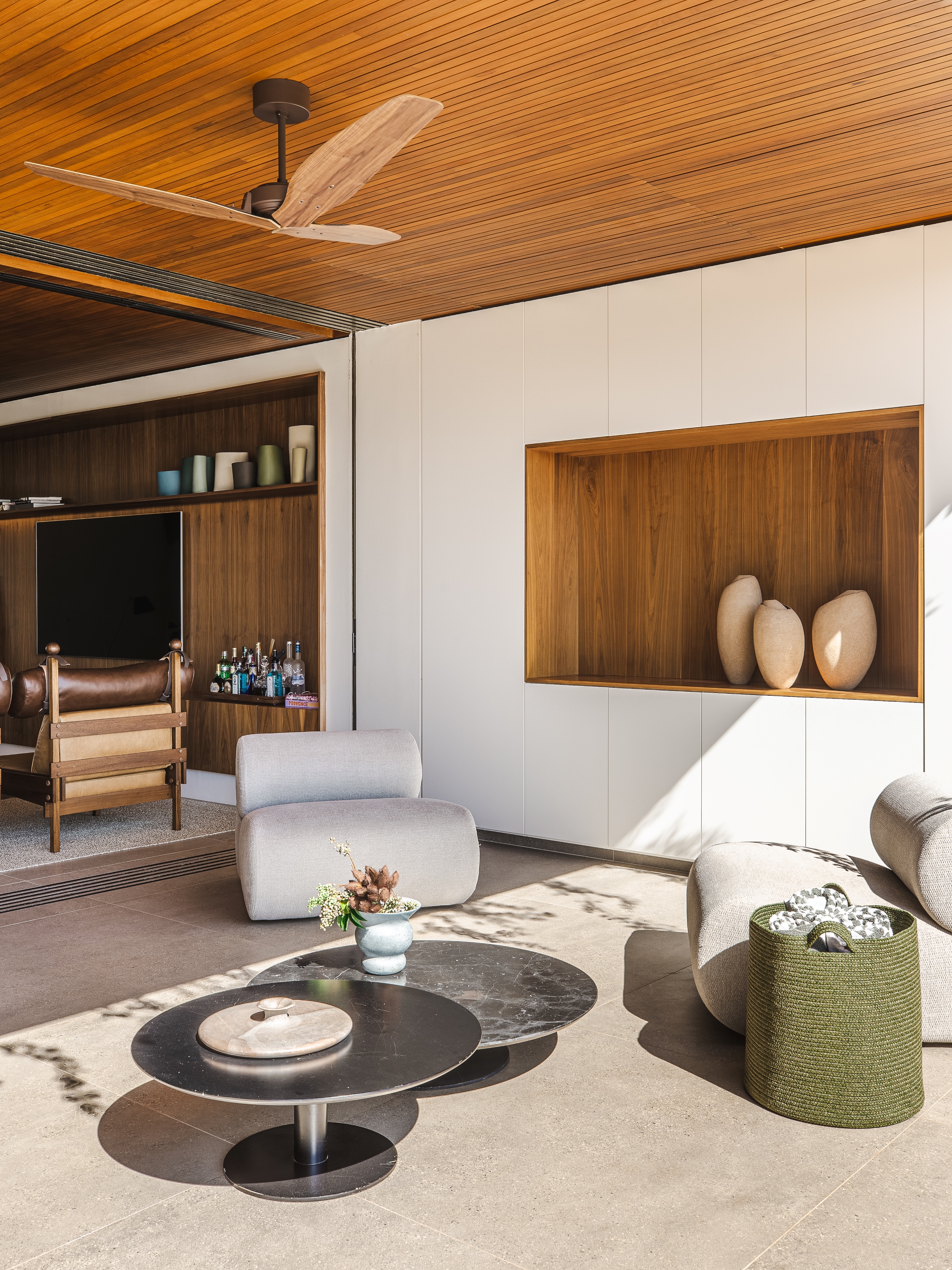 Contemporary furniture is matched with Brazilian modernist icons, including the Tonico chair at rear left