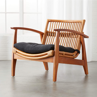 Rattan accent chair with black cushion