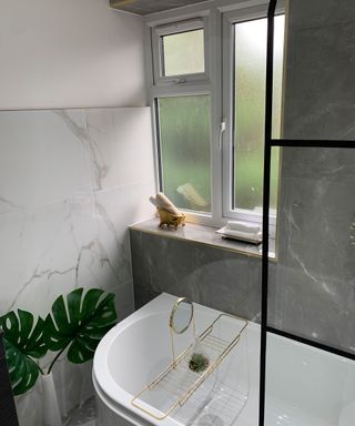 Free standing white bath with crittall-style windows