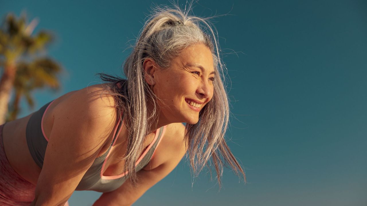 A woman looks happy after working out