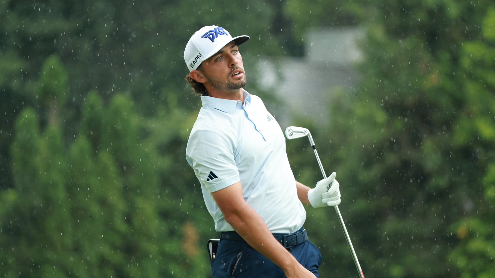 Marco Penge watches his iron shot in the rain