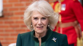 Queen Camilla arrives at Barnardo's in a convoy of electric taxis which will transport Paddington teddy bears to Barnardo's Nursery in Bow on November 24, 2022