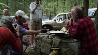 A runner talking to race officials in The Barkley Marathons: The Race That Eats Its Young