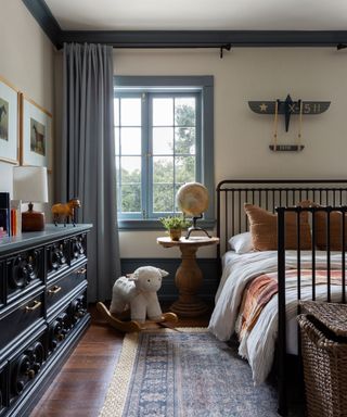 childs bedroom with light painted walls and blue painted woodwork cornice and window trims