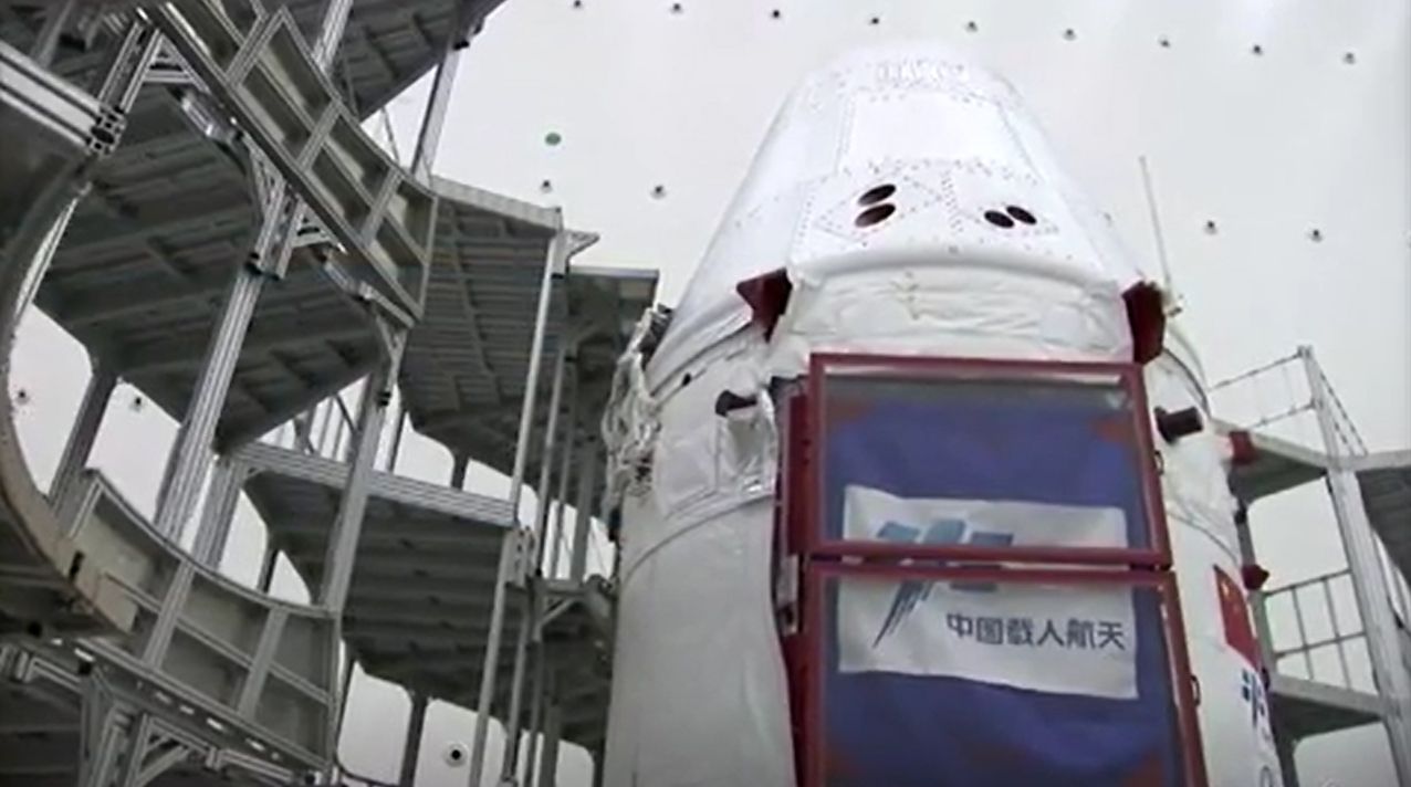 China's next-generation space capsule for astronauts is prepared for its uncrewed test flight on a Long March 5B rocket in these stills from a CCTV state news video. The capsule launched May 5, 2020.