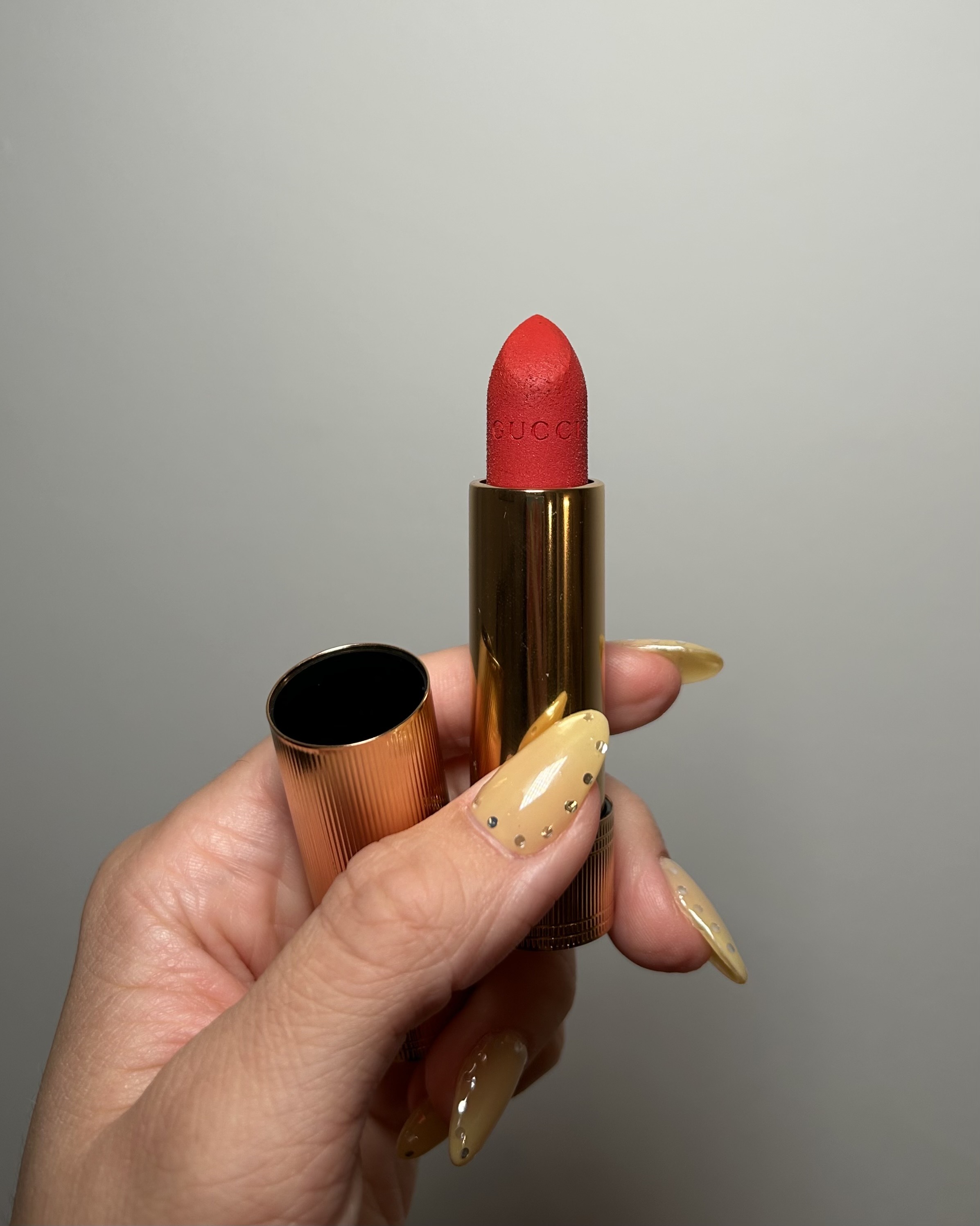 Brascia holding the Gucci Velvet Matte Lipstick.