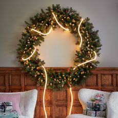 Large green wreath with lights woven around