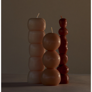 three tall standing candles with stacked rounded shape design