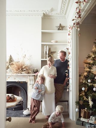 white dining room set for christmas with blonde family