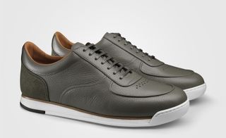 A pair of grey leather casual shoes with white soles.