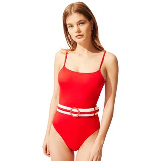 model wearing red belted swimsuit