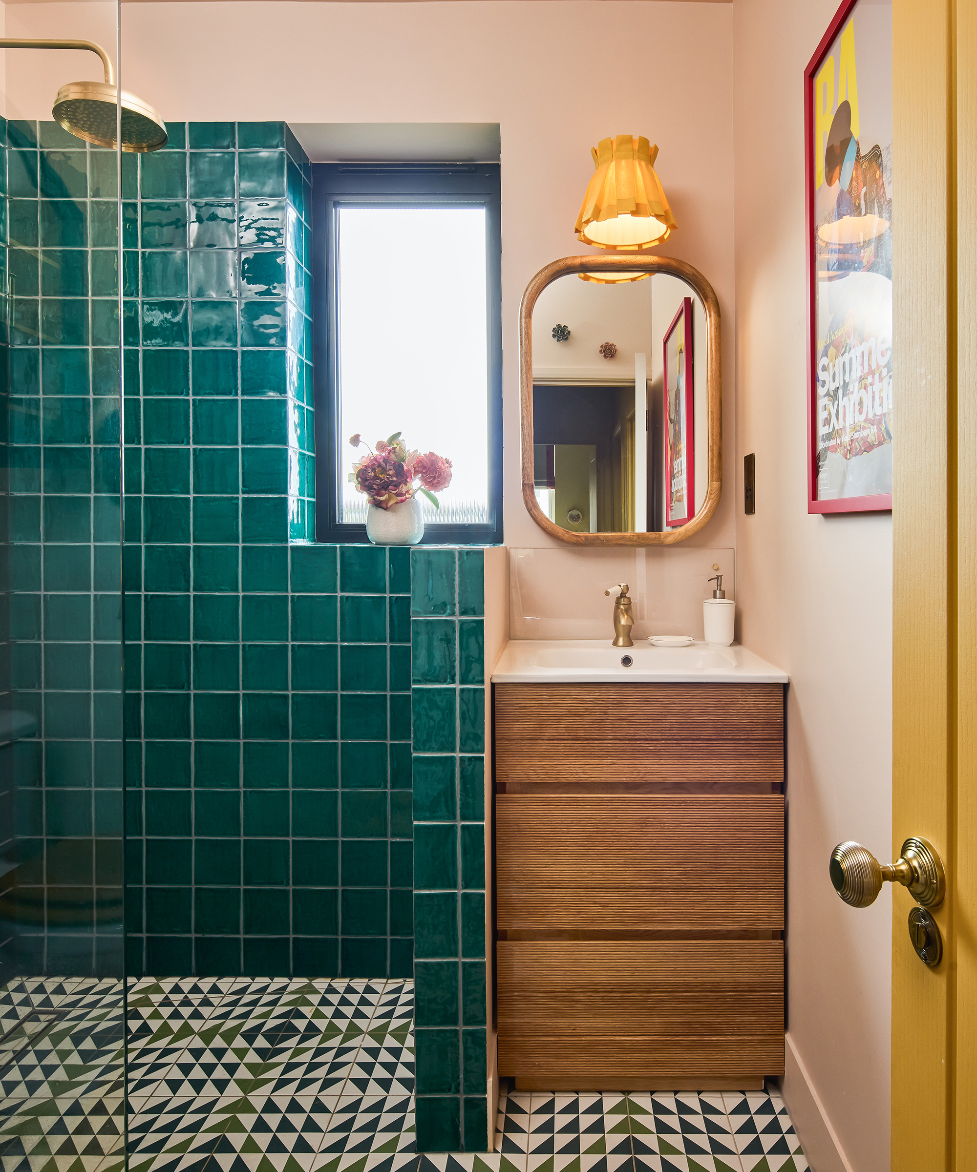 bathroom with wood vanity and green tiled shower