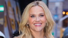 reese witherspoon wearing a blue and brown outfit