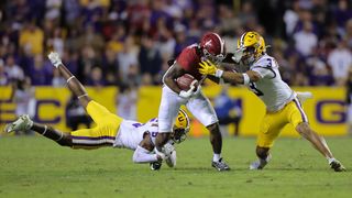 Jahmyr Gibbs #1 of the Alabama Crimson Tide is tackled by Greg Brooks Jr. #3 and Jay Ward #5 of the LSU Tigers during the first half at Tiger Stadium on November 05, 2022 in Baton Rouge, Louisiana.