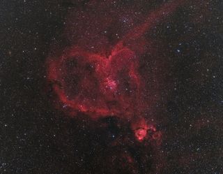 This heart-shaped cloud of cosmic gas and dust is called the "Heart Nebula," or IC 1805. It lies about 7,500 light-years from Earth in the constellation Cassiopeia.