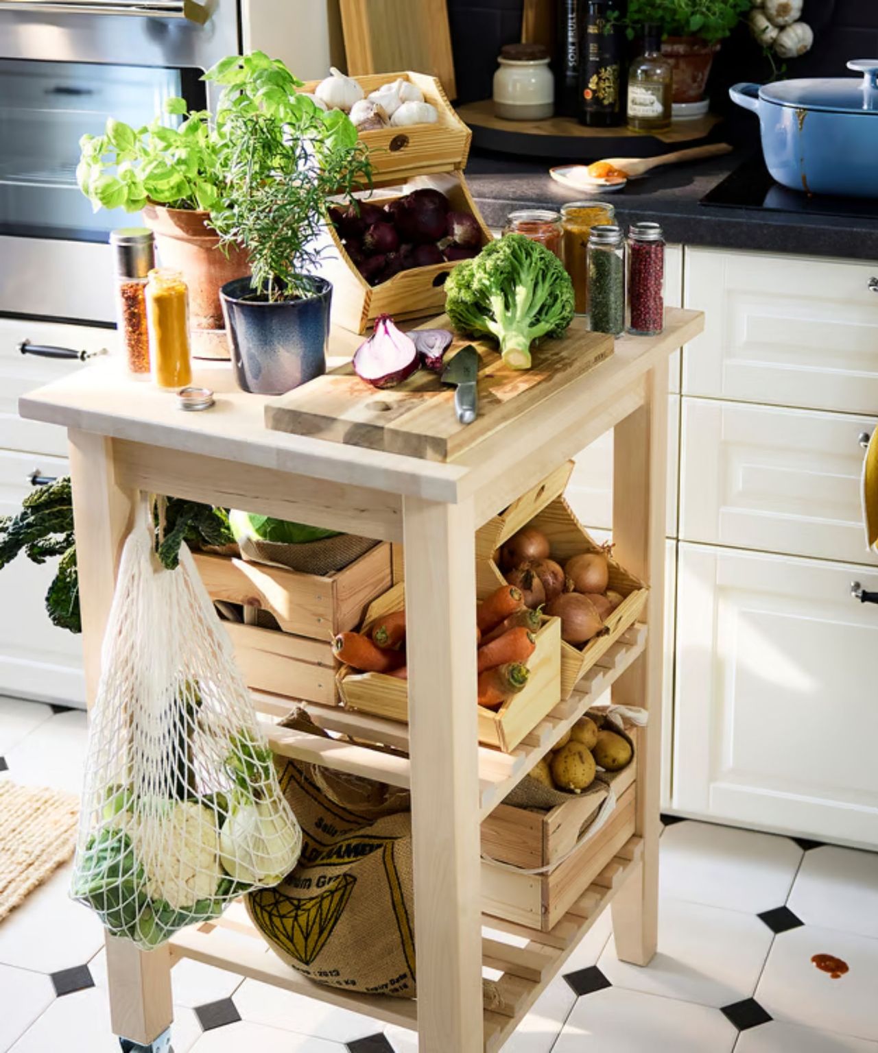 IKEA's stacking food boxes slotted into a rolling small wooden island, pictured with onions and carrots