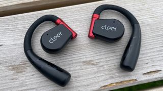 Cleer Arc II Sport headphones on wooden bench