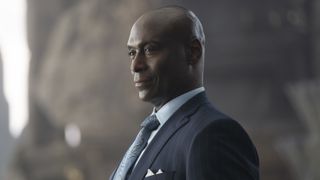 Lance Reddick in a black suit as Zeus in Percy Jackson & The Olympians