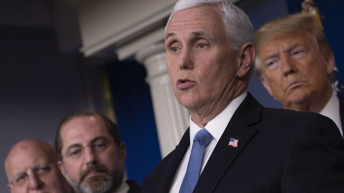 U.S. President Donald Trump listens as Vice President Mike Pence speaks during a news conference on the COVID-19 outbreak on Feb. 26, 2020.