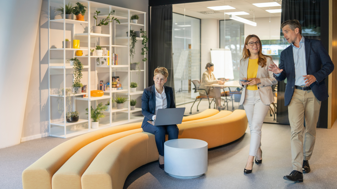 man and woman walking in open-spaced office