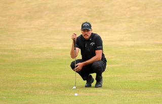 Anthony Quayle crouches down behind a putt at St Andrews - 2022 Open Championship