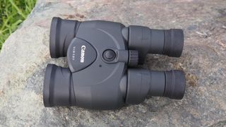 Canon 12x36 IS III binoculars on a rock