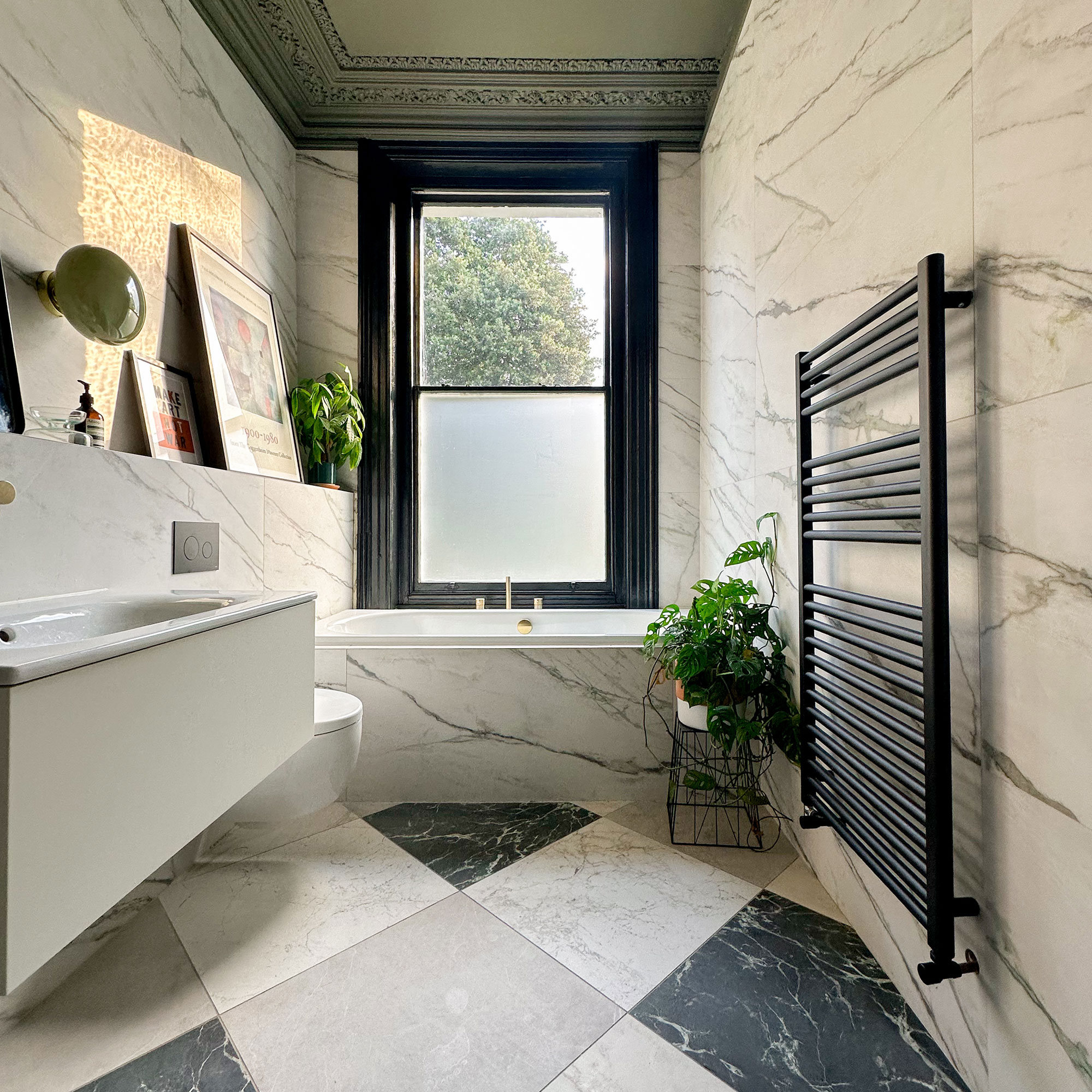 Bathroom with chequered floor, tiled bath and walls and dark green ceiling