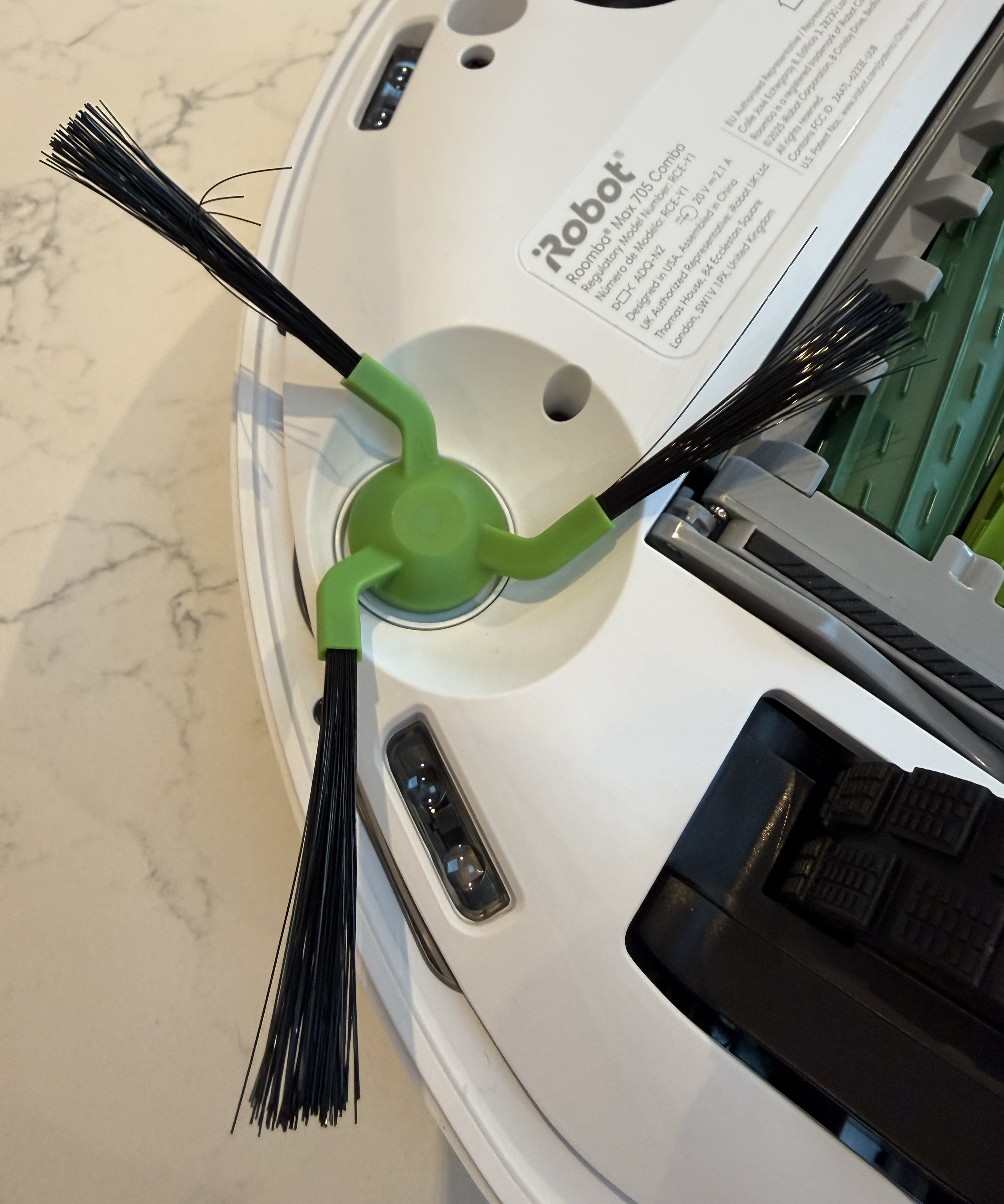 The edge brush on the underside of the Roomba is pictured
