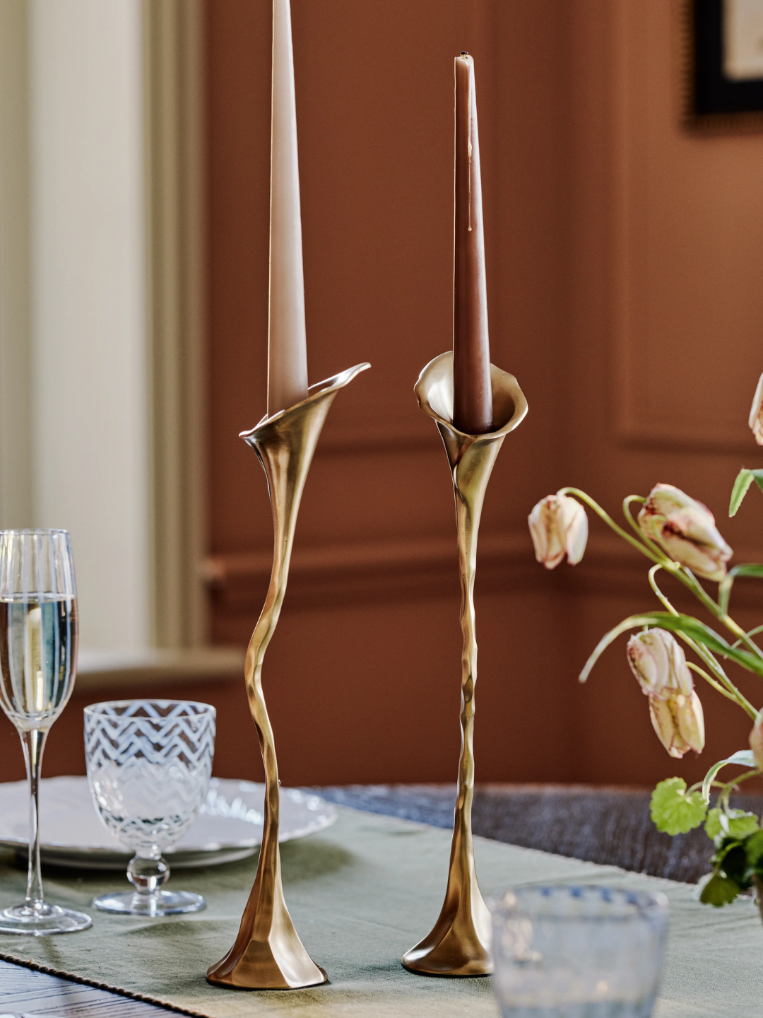 A pair of brassy calla lily shaped candle holders from OKA
