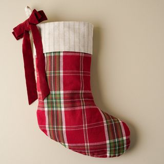 Vintage Christmas Plaid Stocking against a beige background.