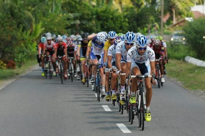Tabriz Petrochemical Cycling Team Iran riders lead the big peloton during stage 6 Tour de Singkarak 2013, start from Pariaman-Painan, distance 144,5 km.