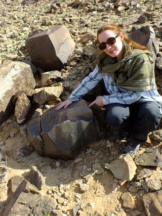 Study lead researcher Eleanor Scerri with a giant Acheulean core, which was struck to create hand ax flakes.