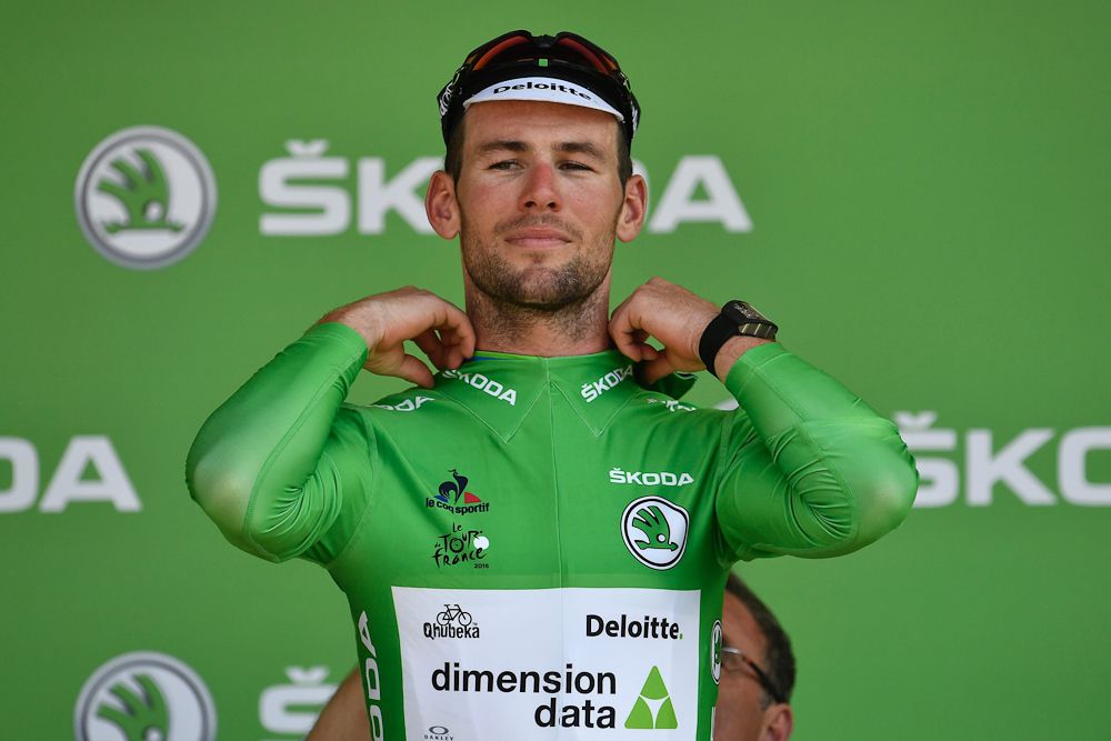 Mark Cavendish pulls on the green jersey after winning stage 6 of the 2016 Tour de France.