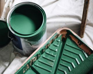 A can of green paint and painting tray