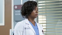 Simone Griffith (played by Alexis Floyd) has a worried expression on her face as she looks into a hospital room from the window on Grey's Anatomy.