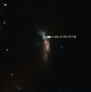 The location of the bright supernova SN 2010jl in the dwarf galaxy UGC 5189A is shown in this image captured by the NASA/ESA Hubble Space Telescope. A new study of the supernova by astronomers using the Very Large Telescope at the European Southern Observatory in Chile has revealed a new glimpse into how dust forms around supernovas.