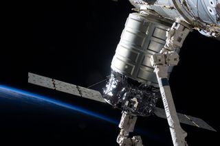 The first Cygnus commercial cargo spacecraft built by Orbital Sciences Corp. is seen here attached to the International Space Station's Harmony node, after arriving at the station on Sept. 29, 2013.