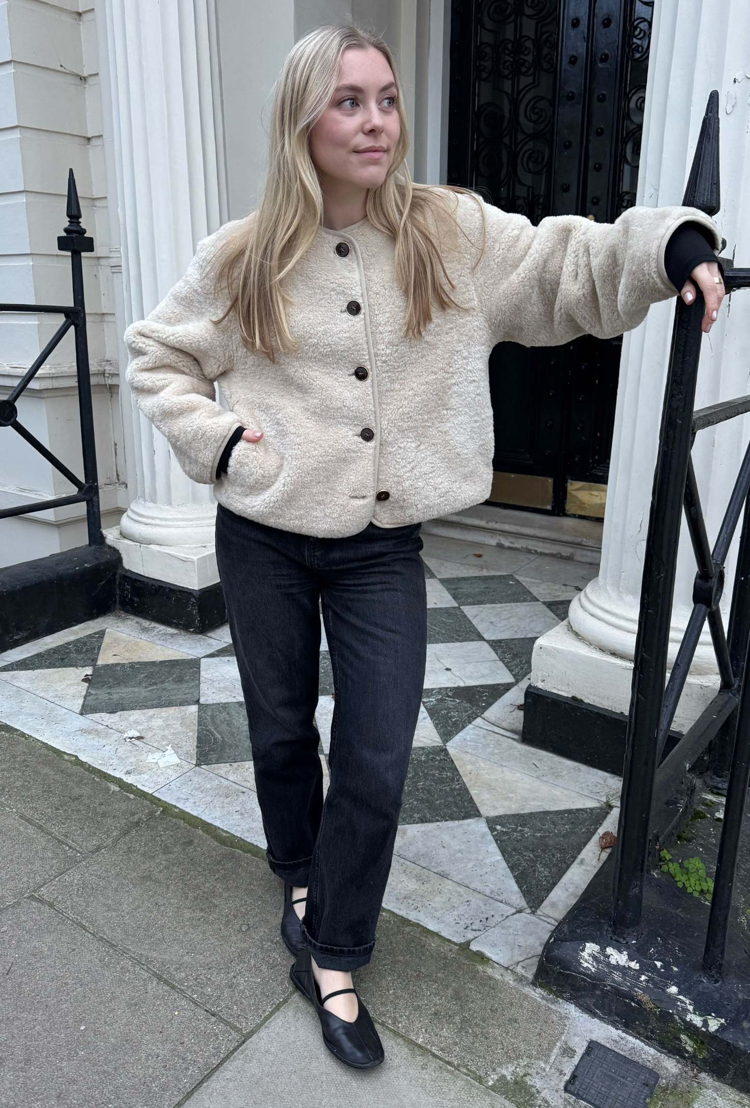 An editor from Who What Wear UK modelling a teddy coat.